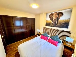 a bedroom with a large bed with a picture of an elephant at Residencia Pista Llarga in La Molina +56 photos