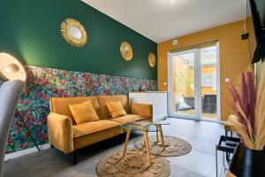 a living room with a couch and a table at L'Amazonia in Croix +17 photos