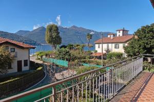 a balcony with a view of the water and mountains at Casa Rosanna al lago in Maccagno Inferiore
