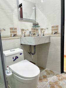 a bathroom with a toilet and a sink at VICTORIA hotel in Can Tho +21 photos