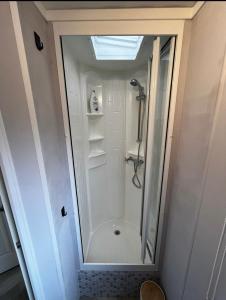 a shower with a glass door in a bathroom at Stekkie 49 in Schagen +8 photos