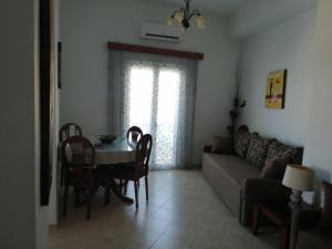 a living room with a table and a couch at Lenio's Home in Pera Gyalos