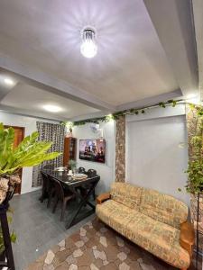 a living room with a couch and a table at Bahay ni Kuya in San Pablo