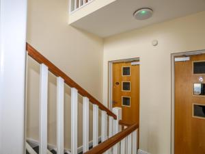 a staircase in a home with white walls at Tides Reach in Rhosneigr