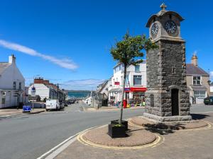 a clock tower in the middle of a street at Tides Reach in Rhosneigr