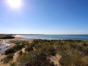 a view of the beach from the bluff at Tides Reach in Rhosneigr