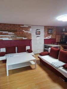 a living room with two couches and a brick wall at Haus Melzer in Öhringen