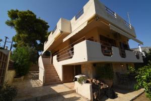 a large house with stairs in front of it at Villa Erato in Kineta
