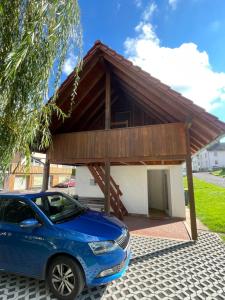 a car parked in front of a garage at Ferienhaus Wehretal - auf separatem Grundstück in Langenhain