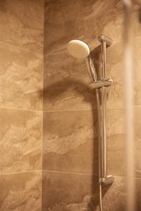 a shower stall with a shower head in a bathroom at TOR'RE Astana, Trademark Collection by Wyndham in Astana