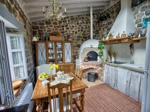 a kitchen with a table and a brick wall at La Curva De María in Terán