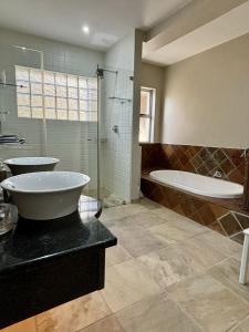a bathroom with a tub and a sink and a shower at Blue Dawn, Tsitsikamma in Eersterivierstrand