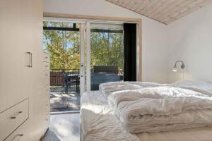 una camera da letto con due letti e una porta scorrevole in vetro di Lovely Holiday Home By Beach And Nature At Lyngså a Sæby