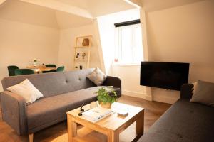 a living room with a couch and a table at PURMERENT Apartments in Purmerend