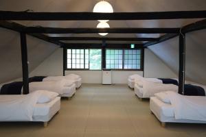 A bed or beds in a room at 古民家宿rootfield