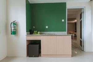 a kitchen with a counter and a green wall at Diane Residences in Mabolo