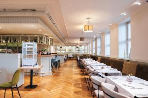 a row of tables and chairs in a restaurant at Hotel Zum Erbprinzen in Schwetzingen