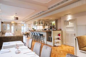 a restaurant with tables and chairs and a bar at Hotel Zum Erbprinzen in Schwetzingen +23 photos