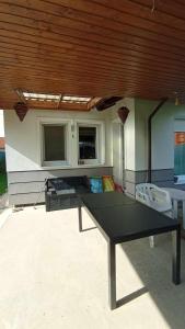 a ping pong table in front of a house at Klau & Bali Apartmanház Sopron in Sopron