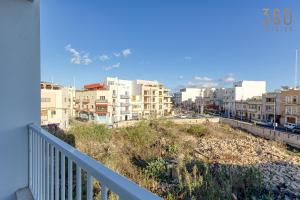 a view of a city from a balcony at Spacious & Cosy 3BR Apt with Private Balconies by 360 Estates in Fgura