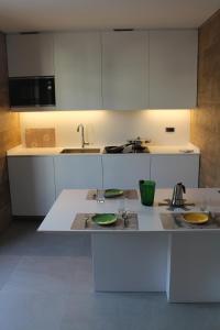 a kitchen with white cabinets and a counter top at Casa Coltura in Bormio