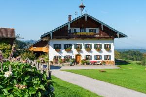 a large white house with a gambrel roof at Stadlerhof in Frasdorf