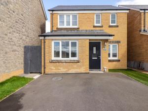 a brick house with a driveway in front of it at 69 Ffordd Y Meillion in Llanelli