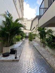 a courtyard of a building with palm trees at SimpleStay Chatuchak, SureStay Collection by Best Western in Bangkok