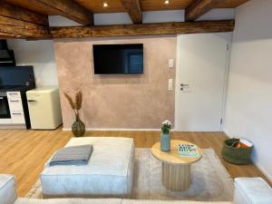a living room with a couch and a table at Erholungsloft in Bad Buchau