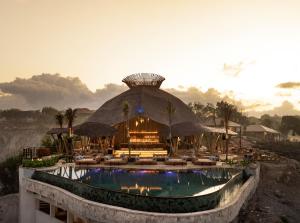 a resort with a swimming pool and a large building at ARNA Suites and Ocean Lounge in Nusa Lembongan