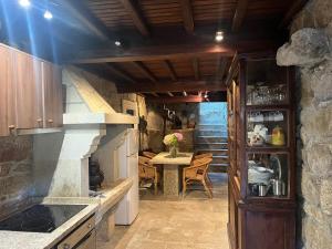 a kitchen with a table and a counter top at El Limonero in Combarro