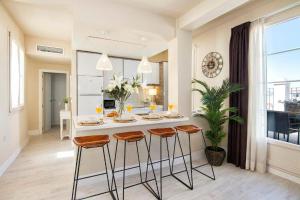 a kitchen with a table and stools in a room at Penthouse Lorena in Granada