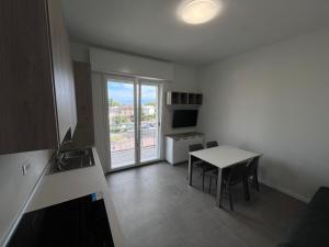 a small kitchen with a table and a window at Dealuna Motel in Fidenza +27 photos