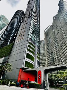 a tall building with a traffic light in front of it at Sky Suites KLCC BY Arman in Kuala Lumpur