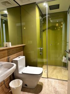 a bathroom with a toilet and a glass shower at Sky Suites KLCC BY Arman in Kuala Lumpur +67 photos