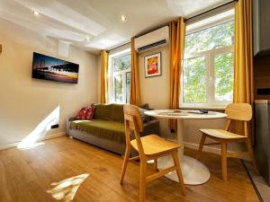 a living room with a couch and a table at 2nd floor Casa Kungu Street in Liepāja
