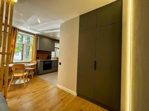 a room with a kitchen and a dining room at 2nd floor Casa Kungu Street in Liepāja +2 photos