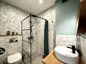 a bathroom with a sink and a shower at 2nd floor Casa Kungu Street in Liepāja