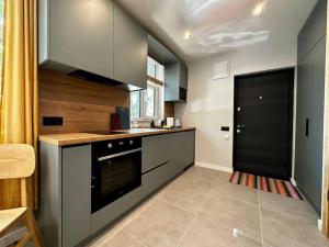 a kitchen with a stove and a black oven at 2nd floor Casa Kungu Street in Liepāja