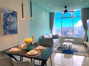 a living room with a table and a couch at Sky Suites KLCC BY Arman in Kuala Lumpur