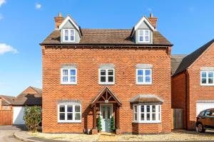 an image of a red brick house at 5BR Hinckley l Sleeps 10 l 2 Big Parking l House in Hinckley
