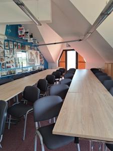 a conference room with a long table and chairs at WOSiR Szelment in Jeleniewo