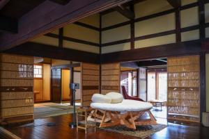 a living room with a bench and a table at Hanakaijichi, Explore the crustal movement every thousand years in Kuroshima