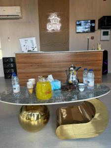 a table in a room with a counter with drinks on it at The Out in Sinādil +32 photos