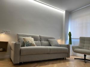 a living room with a couch and a chair at Luxury Gran Vía centro Murcia in Murcia