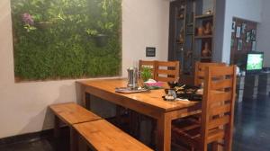 a wooden table and chairs in a room at Shruthi's Aarohi-Nature's Retreat Homestay in Kannur