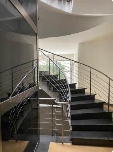 a staircase in a building with metal railing at Casa Vacanza LaReggia con garage in San Prisco +38 photos