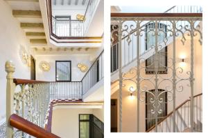 a staircase in a house with wrought iron railings at Casa Bedoya Suites & Colors by Magno Apartments in Seville