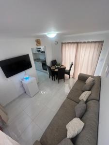 a living room with a couch and a table at Kiki's Inn Self-Catering & accommodation in Swakopmund