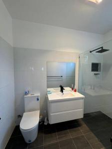 Un baño con inodoro, lavabo y ducha. en Shoaly House Cottage - A charming coastal escape, en Shoal Bay 36 fotos más